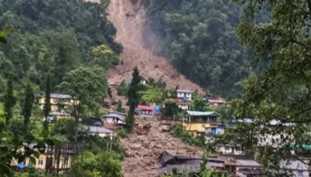 पहाड़ी पर भूस्खलन के बाद एक गाँव का हवाई दृश्य, जिसमें कई घर मलबे से ढके हुए हैं।